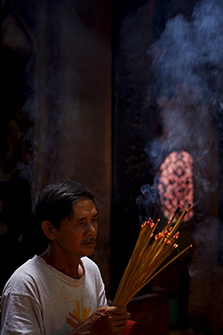 Man with joss sticks, Hue, Vietnam, Indochina, Southeast Asia, Asia