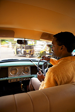 Kerela 1950's Ambassador car with driver, busy Keralan street through windscreen, India, Asia