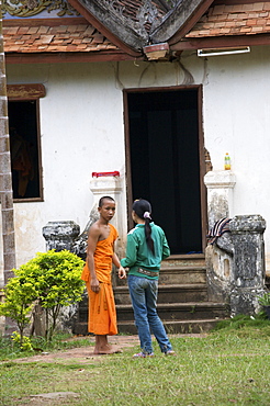 A young monk and his sister in Luang Prabang, Laos, Indochina, Southeast Asia, Asia