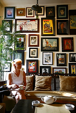 Woman having a tea in a lounge of the Batavia Cafe, the most famous colonial place of Jakarta, Java, Indonesia, Southeast Asia, Asia