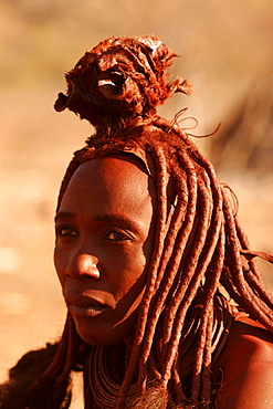 Young Himba woman wearing wedding finery, near to the Epupa falls on the border with Angola, Namibia, Africa