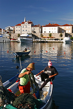 Fishermen in front of the small city of Budva, Montenegro, Europe