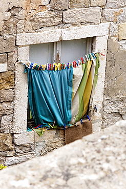 Stone window frame with hanging washing in Dubrovnik, Croatia, Europe