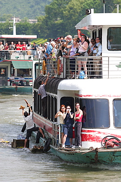 Locals attempt to sell trinkets to tourists viewing the sugar loaf mountains that make Guilin famous in southern China, China, Asia