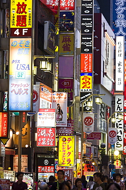 A side street in the busy Shinjuku district, full of colourful signs and adverts, Tokyo, Japan, Asia