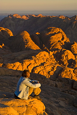 Tourist watching the sunrise on top of Mount Sinai, Egypt, North Africa, Africa