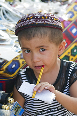 Young boy with pen in his mouth, Khiva, Uzbekistan, Central Asia, Asia