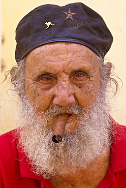 An old man with cap and white beard smoking a cigar, Havana, Cuba, West Indies, Central America