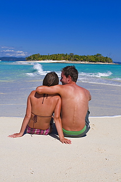 Happy couple on their honeymoon at the beautiful beach of Nosy Iranja near Nosy Be, Madagascar, Indian Ocean, Africa