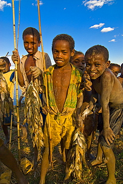 Young curious and dirty kids coming from fishing, Madagascar, Africa