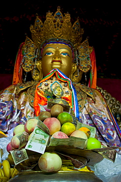 Buddha with sacrifical offerings in a little temple in Lhasa, Tibet, China, Asia