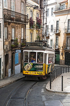 Famous tram 28 going through the old quarter of Bario Alto, Lisbon, Portugal, Europe