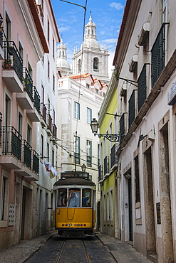 Famous tram 28 going through the old quarter of Alfama, Lisbon, Portugal, Europe