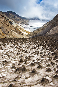 Little sand mounds on a glacier field on Mutnovsky volcano, Kamchatka, Russia, Eurasia 