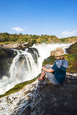 Woman looks at the stunning Murchison Falls (Kabarega Falls), Murchison Falls National Park, Uganda, East Africa, Africa