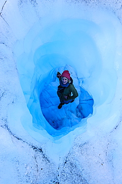 Woman standing in an Ice cave in the Fox Glacier, Westland Tai Poutini National Park, South Island, New Zealand, Pacific