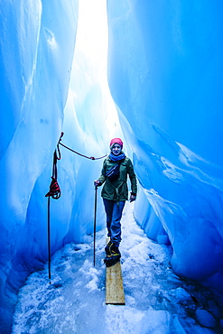 Woman standing in an ice cave, Fox Glacier, Westland Tai Poutini National Park, South Island, New Zealand, Pacific