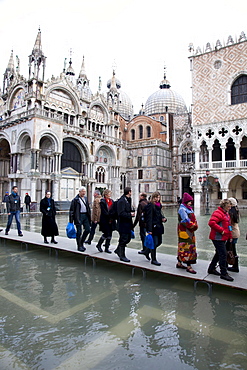 Tourists walking on footbridges during high tide in St. Mark's Square, Venice, UNESCO World Heritage Site, Veneto, Italy, Europe