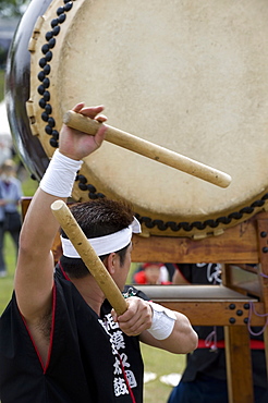 Drummer performing on a Japanese taiko drum at a festival in Kanagawa, Japan, Asia