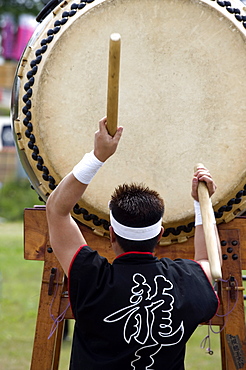 Drummer performing on a Japanese taiko drum at a festival in Kanagawa, Japan, Asia