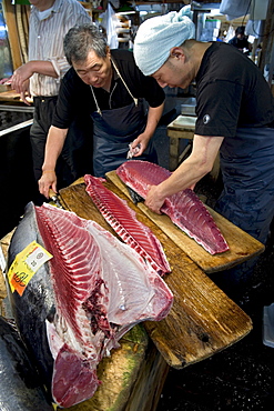 Cutting fresh tuna at Tsukiji Wholesale Fish Market, the world's largest fish market in Tokyo, Japan, Asia