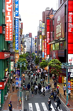 A pedestrian street lined with shops and signboards attracts a crowd in Shinjuku, Tokyo, Japan, Asia