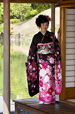 A 20-year old Japanese girl wearing spring furisode kimono with long sleeves to indicate her single social status, Japan, Asia