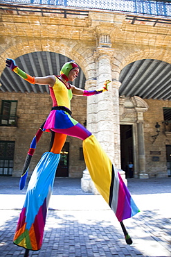 Performer in the street in Old Havana walking on stilts, Havana, Cuba, West Indies, Central America