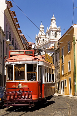 A tram runs along the tourist friendly Number 28 route in Alfama, Lisbon, Portugal, Europe