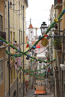 An alley is decorated with tinsel and colour for the annual Festival of St. Anthony in the Bica district of Lisbon, Portugal, Europe