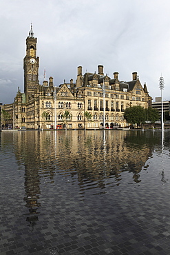 Bradford City Hall, a Venetian Gothic facade, reflects in Centenary Square fountain, Bradford, West Yorkshire, Yorkshire, England, United Kingdom, Europe