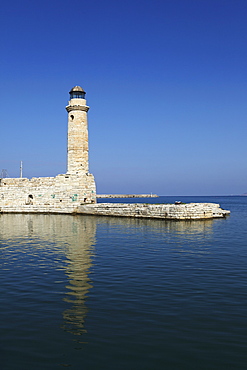 The Venetian era harbour walls and lighthouse at the Mediterranean port of Rethymnon, Crete, Greek Islands, Greece, Europe