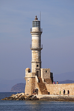 The Venetian era harbour walls and lighthouse at the Mediterranean port of Chania (Canea), Crete, Greek Islands, Greece, Europe