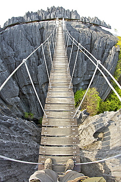 View of suspension bride spanning the Grand Tsingy landscape of limestone karst in the Tsingy de Bemaraha National Park, UNESCO World Heritage Site, western Madagascar, Madagascar, Africa