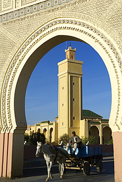 A man on a horse drawn cart passing through the traditional Bab (gates) to the town of Rassani in eastern Morocco