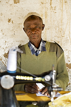 Tailor with sewing machine in Guludo village in the Quirimbas National Park in northern Mozambique, Africa