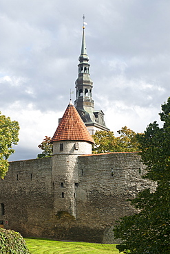 View of St. Nicholas' Church steeple and part of the wall of the old town in Tallinn, UNESCO World Heritage Site, Estonia, Baltic States, Europe