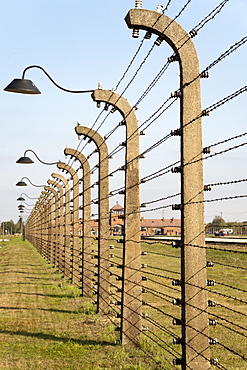 Electrified barbed-wire fencing and buildings at the museum of the former Auschwitz II-Birkenau concentration camp, UNESCO World Heritage Site, Poland, Europe