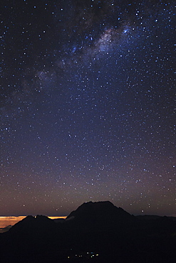 The Milky Way over the mountains encircling the Cirque de Mafate caldera on the French island of Reunion in the Indian Ocean, Africa