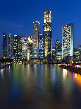 Boat Quay and the Singapore skyline and river at dusk.