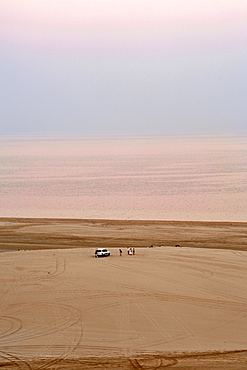 Visitors and their 4X4 at the Inland Sea (Khor al Adaid) in southern Qatar. 