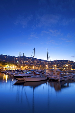 Boats in the Funchal marina in Madeira at dawn.