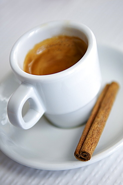 Cup of espresso and a cinnamon stick in a Portuguese cafe.