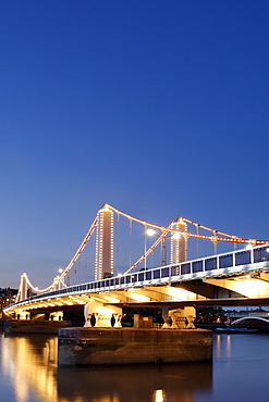 Dusk view of Chelsea Bridge which spans the Thames River in London.