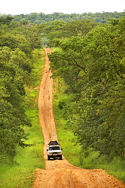 Landcruiser driving along a dirt road in Murchison Falls National Park, Uganda.