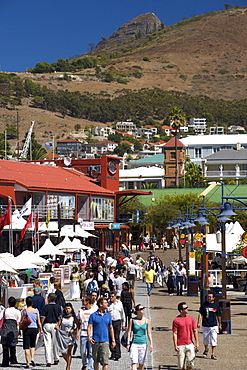 People walking through the waterfront in Cape Town, South Africa.