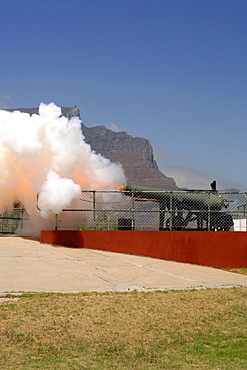 The noon gun firing in Cape Town.
The daily noon gun is Cape Town’s oldest living tradition and the two cannons used are the oldest guns in daily use in the world. They have marked the midday hour in the mother city in this distinctive, albeit noisy manner since early 1806. The cannons were cast in Britain in 1794 and still bear the royal crest of King George the third. The firing of the cannon was originally to give ships in the bay a means of re-setting their clocks accurately.