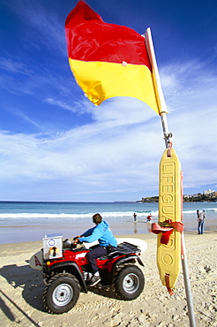 Swimming flag and patrolling lifeguard at Bondi Beach, Sydney, New South Wales, Australia, Pacific