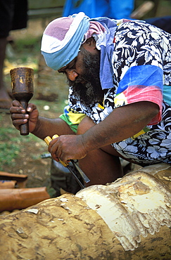 Man carving a statue from a tree trunk at a Melanesian cultural festival in the capital's city centre, Efate Island, Port Vila, Vanuatu