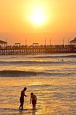 Sunset behind the pier at the popular far north coast fishing & surfing village of Huanchaco, near Trujillo, Peru, South America.